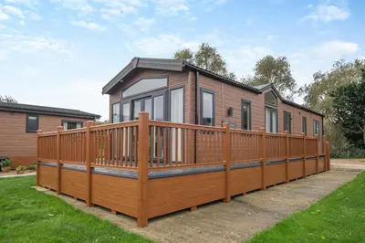 a house with a large deck on a yard at 2 Bed in Welney oc-c30124 in Welney