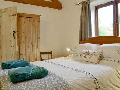 a bedroom with a bed with white sheets and pillows at The Wood Shed - E1919 in Westleton