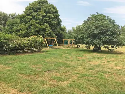 a park with a swing set and a tree at Pheasant in Welney