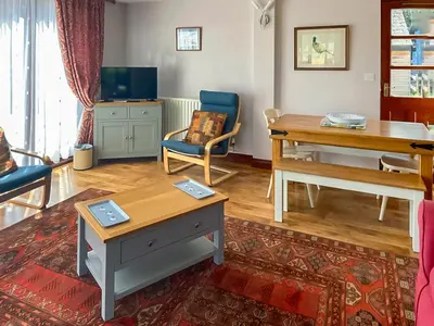 a living room with a table and a desk at Pheasant in Welney
