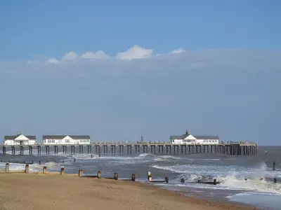 a view of a beach with a pier in the water at The Stables - E3491 in Saxtead