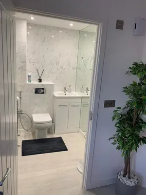 a bathroom with a toilet and a sink at BYK Homes, Hotels and Suites in Grays Thurrock