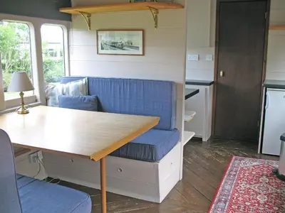 a kitchen and living room with a table and a couch at Railway Carriage One - E5337 in Wetheringsett