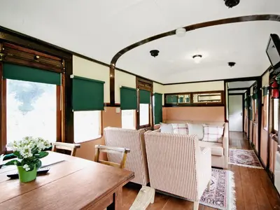 a dining car of a train with a table and chairs at Railway Carriage Two - E5601 in Wetheringsett