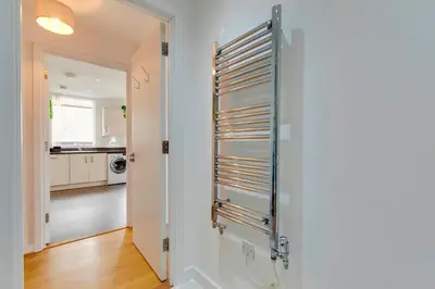 a bathroom with a towel rack on the wall at 54 Woodpecker Way · Modern apartment near Addenbrookes Free parking Pass the Keys in Cambridge