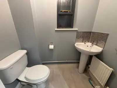 a bathroom with a toilet and a sink at Conveniently located 3 bed spacious home for couples, families and groups in Ipswich in Ipswich