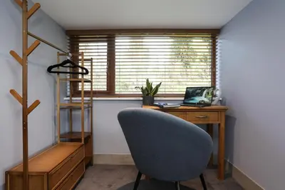 an office with a desk with a chair and a laptop at Oak View Lodge Luxury Master Studio near Ipswich & Woodbridge in Playford