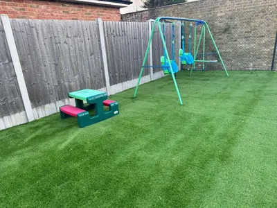 a yard with a playground with a swing at Deluxe Spacious King Size Room in Hornchurch
