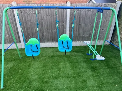 a swing set with three swings at Deluxe Spacious King Size Room in Hornchurch