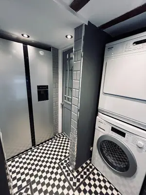 a washing machine in a bathroom with a checkered floor at The Foremans House, With Hot Tub, A luxurious Historical pre 16th Century Grade II Listed House, location Essex in a picturesque Village, Country Pub In walking Distance in Ridgewell