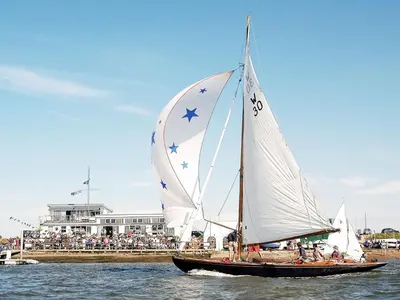 a sail boat with stars on it in the water at Tiger Villa by The Suffolk Cottage Collection in Aldeburgh