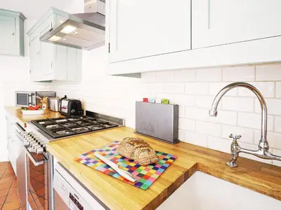 a kitchen with a counter top with a towel on it at Sandpiper Cottage by The Suffolk Cottage Collection in Aldeburgh