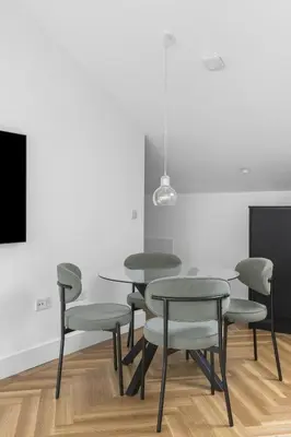 a dining room with tables and chairs and a tv at Navigation Yard in Chelmsford