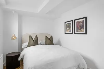a white bedroom with a white bed with pillows at Navigation Yard in Chelmsford