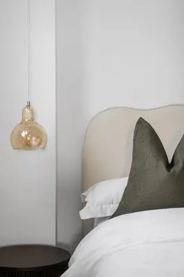 a bedroom with a bed with a pillow and a lamp at Navigation Yard in Chelmsford