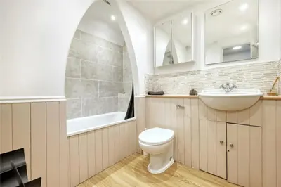 a white bathroom with a sink and a toilet at Blackbrook Farmhouse with free off-street parking for 10 cars in Colchester
