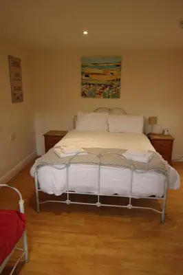 a bedroom with a bed with white sheets and pillows at The Eelsfoot inn in Theberton