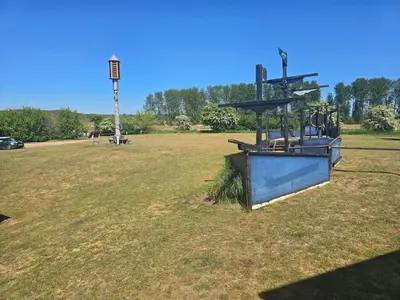 an empty field with a park with a playground at The Eelsfoot inn in Theberton