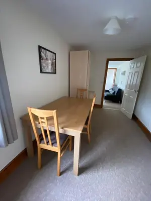 a dining room table and chairs in a room at Two Bedroom Bungalow No2 - Secure Gated Parking in Basildon