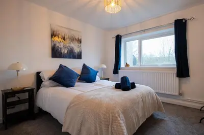 a bedroom with two beds and a window at Kingfisher in Haverhill