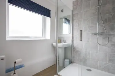 a bathroom with a shower and a sink at Kingfisher in Haverhill