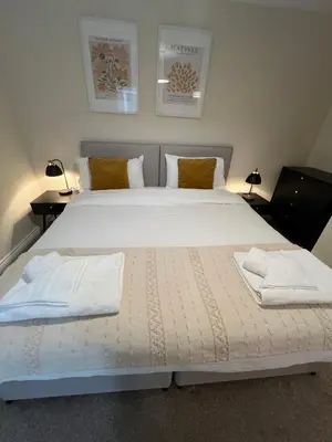 a bedroom with a large bed with two pillows at Grange Luxe 4 in Martlesham Heath