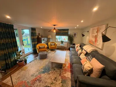 a living room with a couch and a table at The Old Coach House in Hockwold cum Wilton