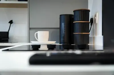 a counter top with cups and a coffee mug at Flat in Royston Town Centre in Royston