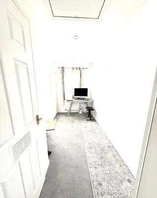 an empty hallway with a door and a desk at Rose home in Haverhill