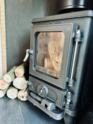 an old fashioned television with a persons foot on the screen at Secret Paddock Shepherds Hut in Hollesley