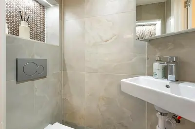 a bathroom with a sink and a toilet at Modern 2 Bed Gem Southend on Sea Free parking in Southend-on-Sea