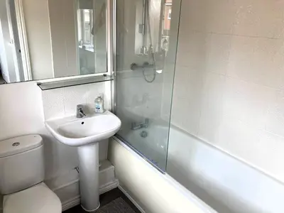 a bathroom with a sink and a toilet and a shower at Detached Place to stay in Essex in Witham