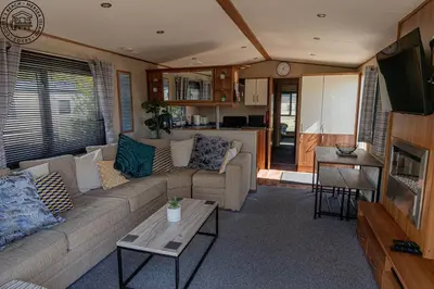 a living room with a couch and a table at Caravan Hire Mersea Island - EOEPS in East Mersea