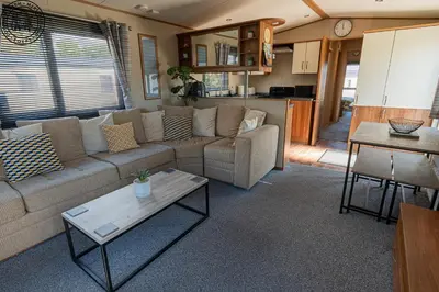 a living room with a couch and a table at Caravan Hire Mersea Island - EOEPS in East Mersea