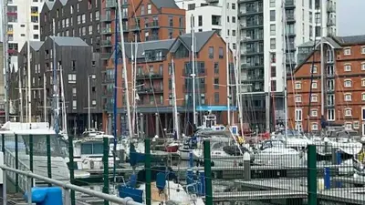 a group of boats docked in a harbor with buildings at Delightful-Ipswich Suffolk-4 Bed-SelfCatering-Contractor-Parking-Wifi in Copdock