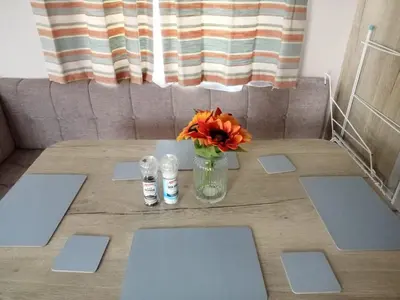 a table with a vase with a flower on it at 911 Caravan in Saint Osyth
