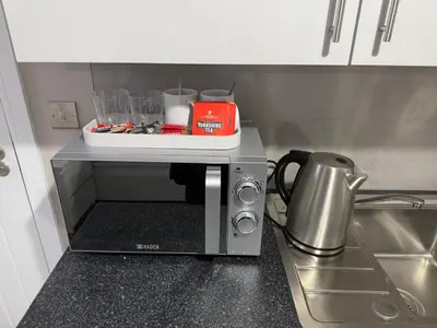 a microwave sitting on a counter in a kitchen at Ryegate House Colchester in Colchester