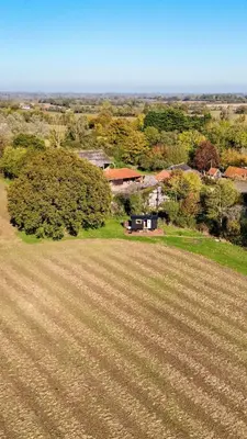 an aerial view of a field with a house and trees at 'Bramley' Hut on private farm in Charsfield