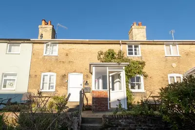 an old brick house with a white door at Ginnys Cottage by Aldeburgh Coastal Cottages in Aldeburgh