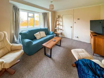 a living room with a blue couch and a coffee table at Lowal House - Uk46054 in Saffron Walden