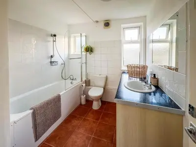 a bathroom with a sink and a tub and a toilet at Lowal House - Uk46054 in Saffron Walden