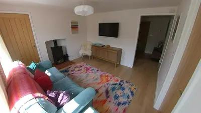 a living room with a couch and a tv at Fully Refurbished 3 bed Victorian Cottage in Tolleshunt D'Arcy in Tolleshunt DʼArcy