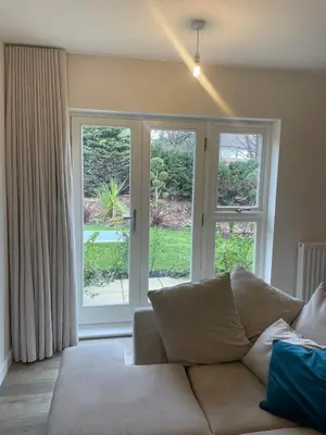 a living room with a couch and sliding glass doors at Prestige 1 bed apartment in Shenfield