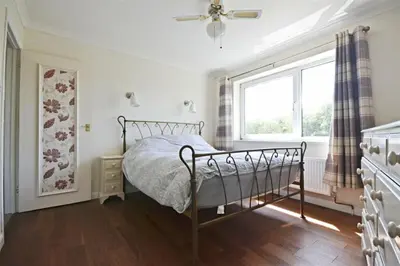 a bedroom with a bed and a window at Modern home in historic market town near airport in Saffron Walden