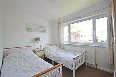 a bedroom with two beds and a window at Modern home in historic market town near airport in Saffron Walden