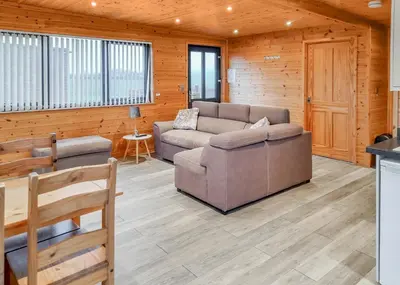a living room with a couch and a chair at Fenview Lakes in Ely