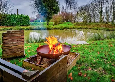 a fire pit in front of a pond at Fenview Lakes in Ely