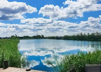 a view of a lake with clouds in the sky at Fenview Lakes in Ely