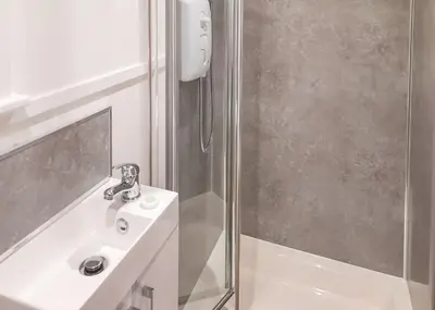 a bathroom with a sink and a shower at Fenview Lakes in Ely
