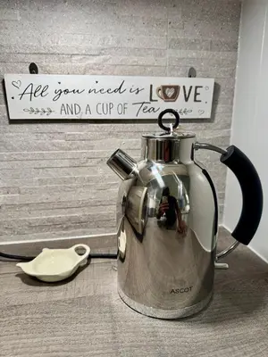 a tea kettle sitting on a counter with a sign at Park Villa, Stevenage in Shephall